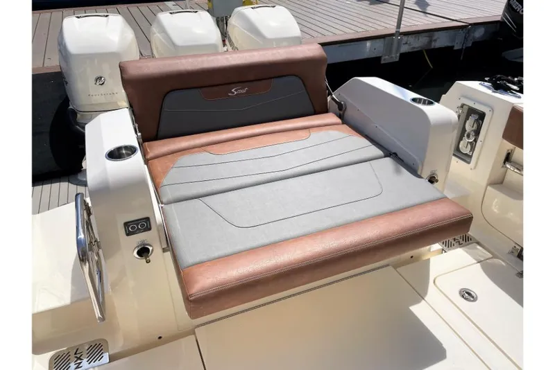Slide: The Image of 2023 Scout 350 LXZ boat seating area with brown and gray upholstery. - 25