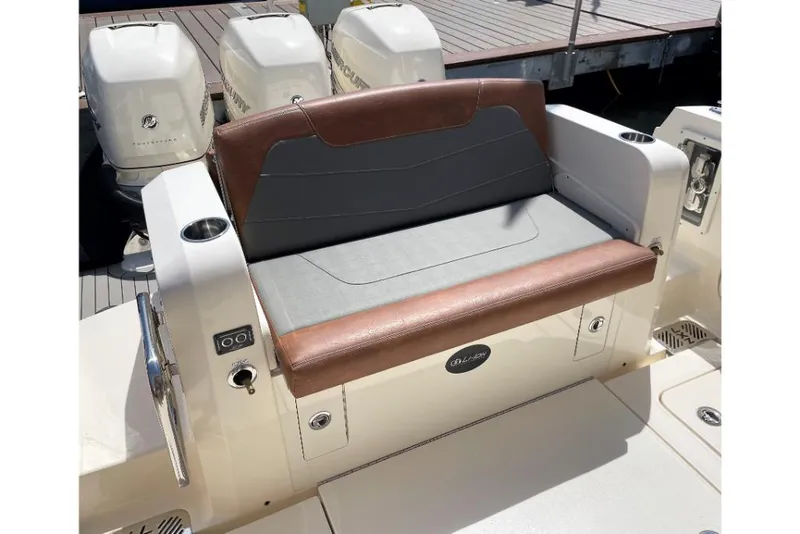 Slide: The Image of 2023 Scout 350 LXZ boat with cushioned seating and twin outboard motors. - 26