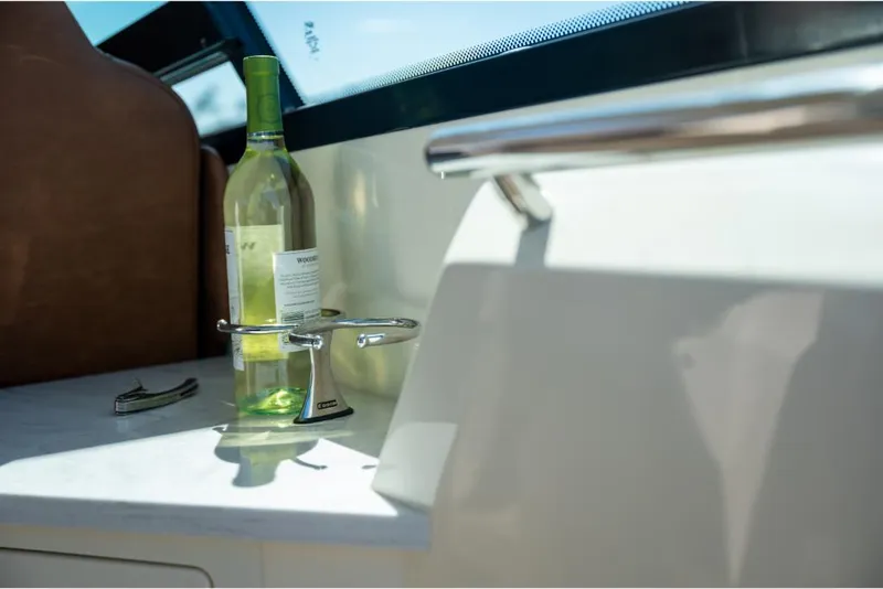 Slide: The Image of 2023 Scout 350 LXZ boat interior with wine bottle on counter. - 27