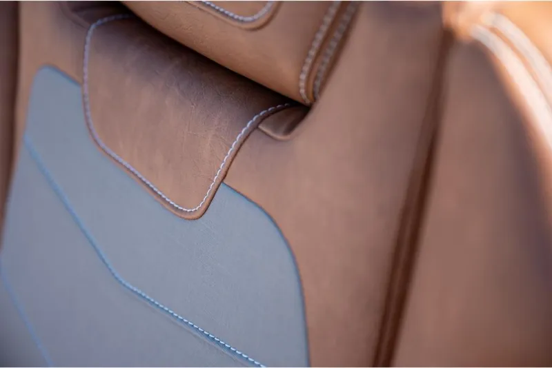 Slide: The Image of 2023 Scout 350 LXZ brown and gray leather seat close-up. - 29