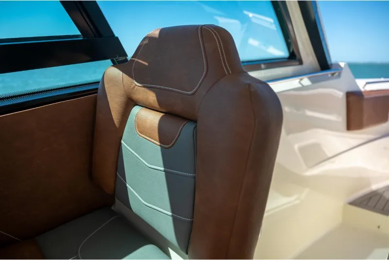 Slide: The Image of 2023 Scout 350 LXZ boat interior seat with brown and gray upholstery. - 30