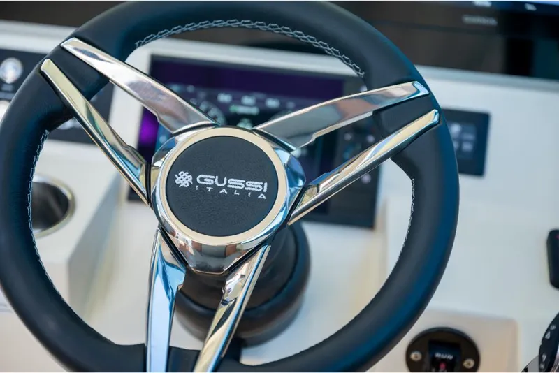 Slide: The Image of Steering wheel of 2023 Scout 350 LXZ boat with Gussi Italia branding. - 33