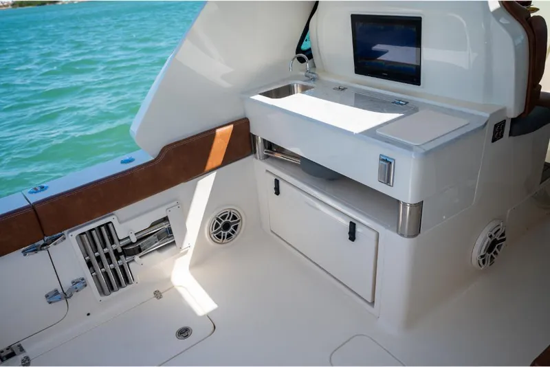 Slide: The Image of 2023 Scout 350 LXZ boat interior with sink and storage compartments. - 35