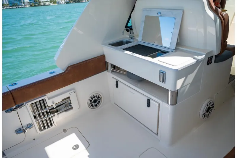 Slide: The Image of 2023 Scout 350 LXZ boat interior with sink and storage compartments. - 36