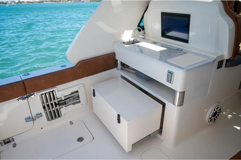 Slide: The Image of 2023 Scout 350 LXZ boat interior with storage compartments and sink. - 38