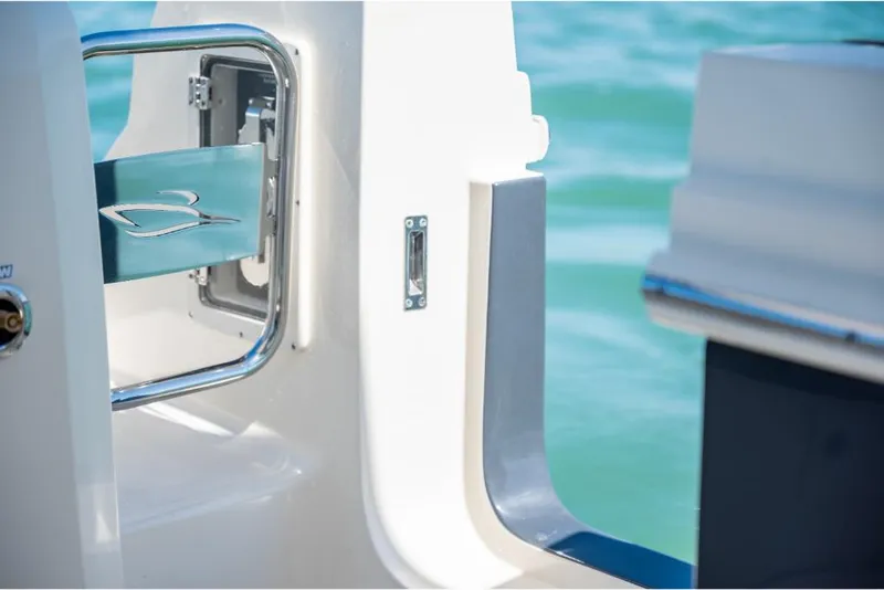 Slide: The Image of 2023 Scout 350 LXZ boat door detail with ocean background. - 39