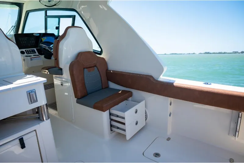 Slide: The Image of Interior of 2023 Scout 350 LXZ boat with brown and gray seating. - 42