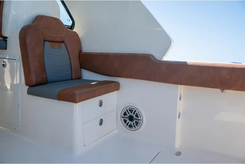 Slide: The Image of 2023 Scout 350 LXZ boat interior with brown and gray seating. - 43
