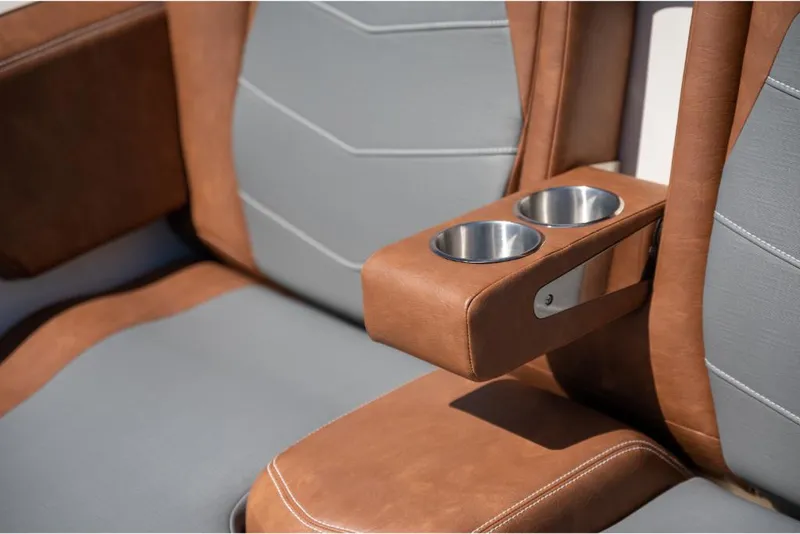 Slide: The Image of 2023 Scout 350 LXZ boat interior with brown and gray leather seats and cup holders. - 44