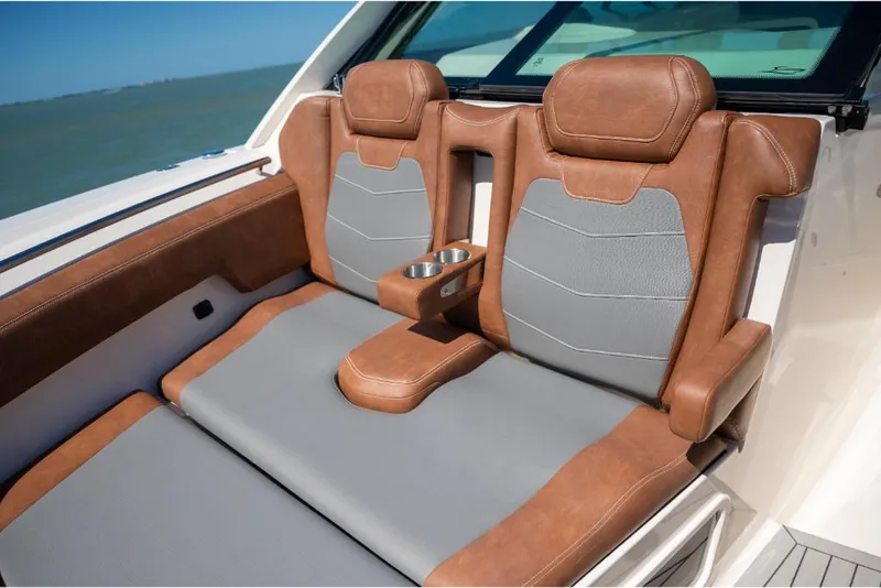 Slide: The Image of 2023 Scout 350 LXZ boat with luxurious brown and gray leather seating. - 45