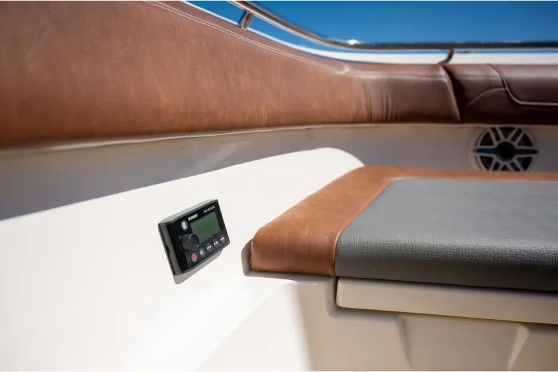Slide: The Image of 2023 Scout 350 LXZ boat interior with brown and gray seating. - 47