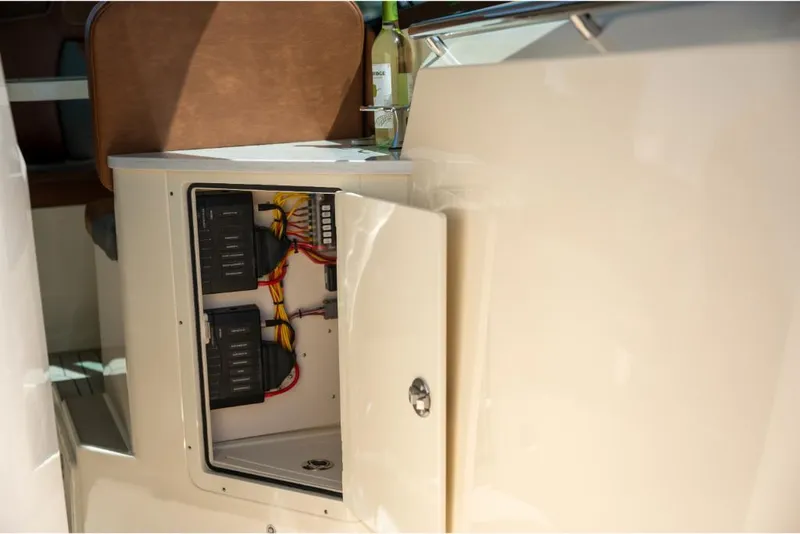 Slide: The Image of 2023 Scout 350 LXZ boat electrical compartment with wiring and components. - 48