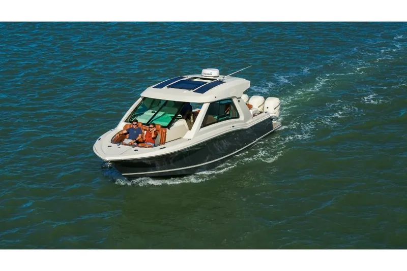 Slide: The Image of 2023 Scout 350 LXZ boat cruising on open water. - 5