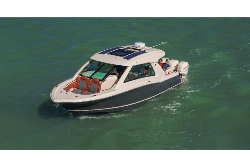 Slide: The Image of 2023 Scout 350 LXZ boat cruising on clear green water. - 6