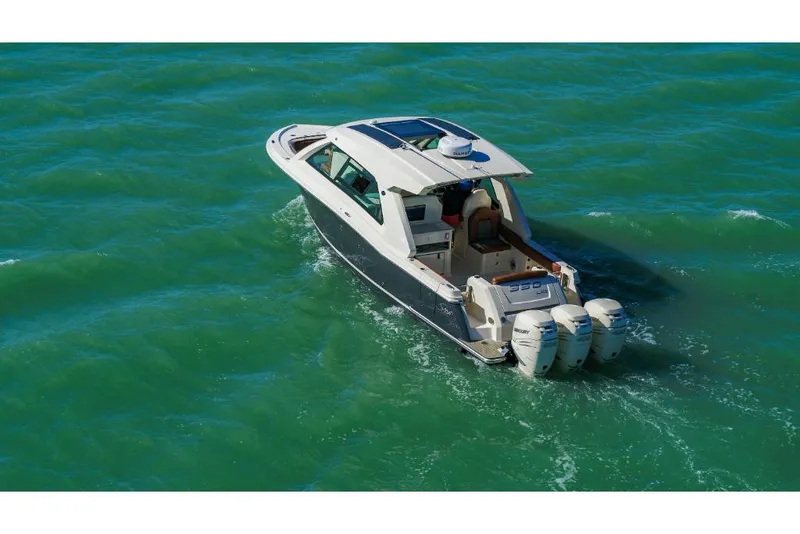 Slide: The Image of 2023 Scout 350 LXZ boat cruising on open water. - 7