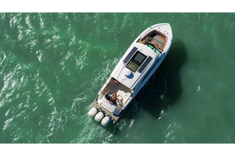 Slide: The Image of 2023 Scout 350 LXZ boat cruising on clear green water. - 9