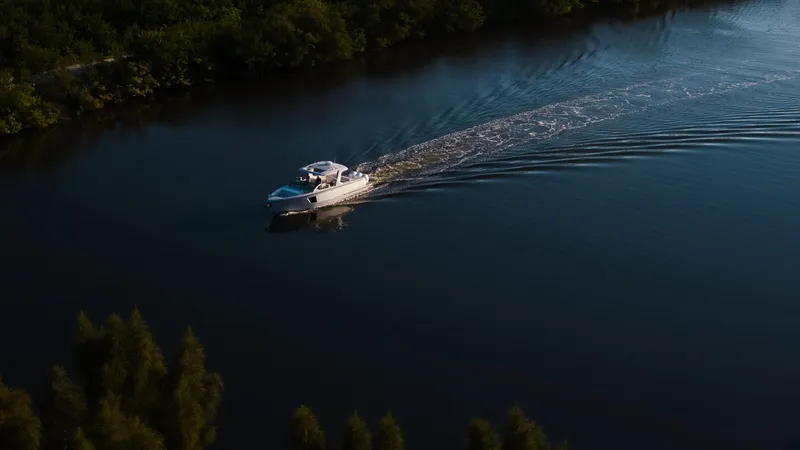 Slide: The Image of 2023 Aviara AV40 Outboard cruising on a serene lake. - 17
