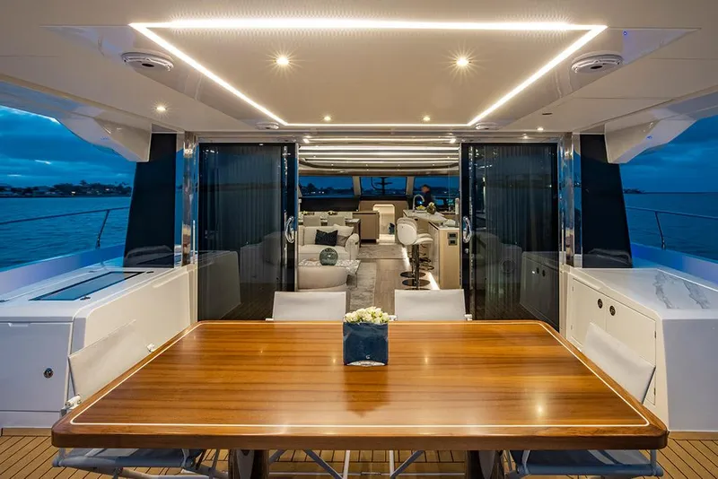 Slide: The Image of Aquila 70 Luxury 2023 yacht interior with elegant dining area and modern lighting. - 13