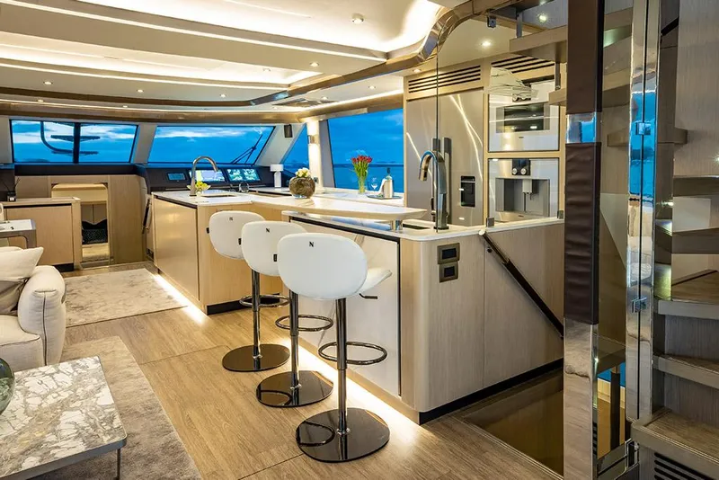 Slide: The Image of Luxurious interior of the 2023 Aquila 70 Luxury yacht with modern kitchen and seating area. - 16