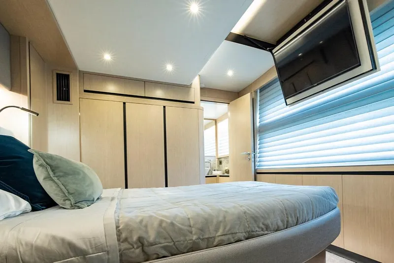 Slide: The Image of Luxurious bedroom interior of 2023 Aquila 70 Luxury yacht with modern decor and flat-screen TV. - 22