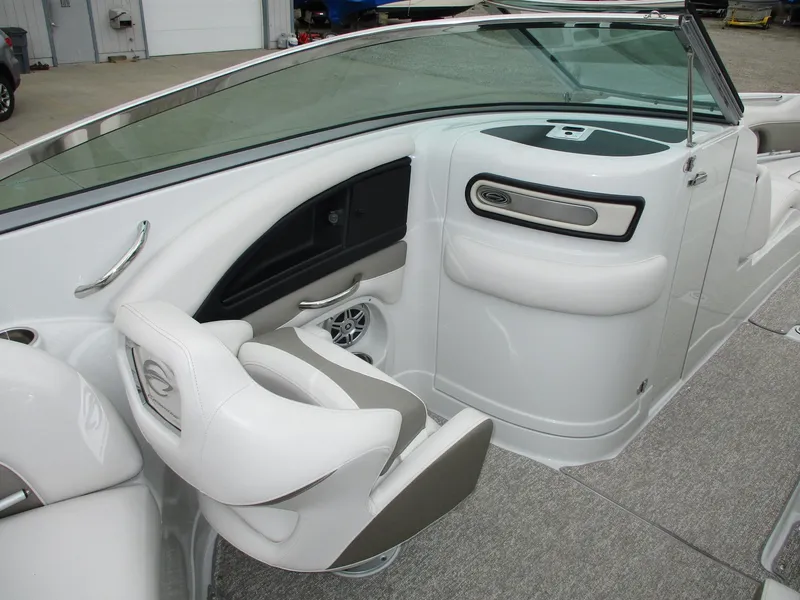 Slide: The Image of Interior of a 2015 Crownline 285 SS boat, featuring white seats and dashboard. - 6
