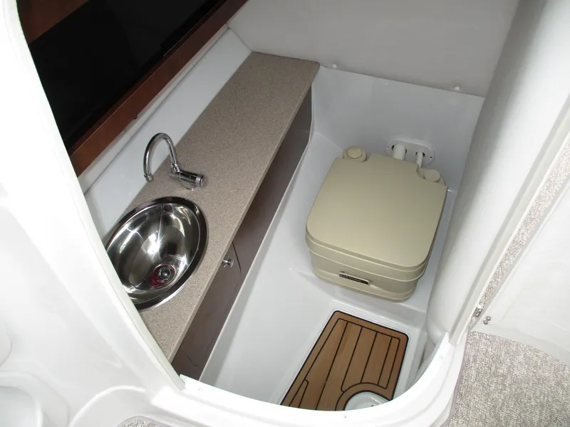Slide: The Image of Interior of 2015 Crownline 285 SS with sink and toilet. - 9