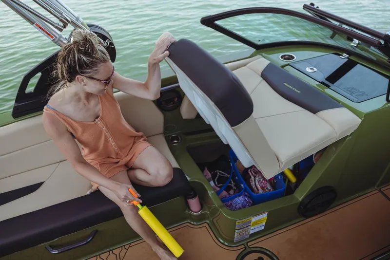 Slide: The Image of Woman organizing storage on a 2023 MasterCraft NXT24 boat. - 16