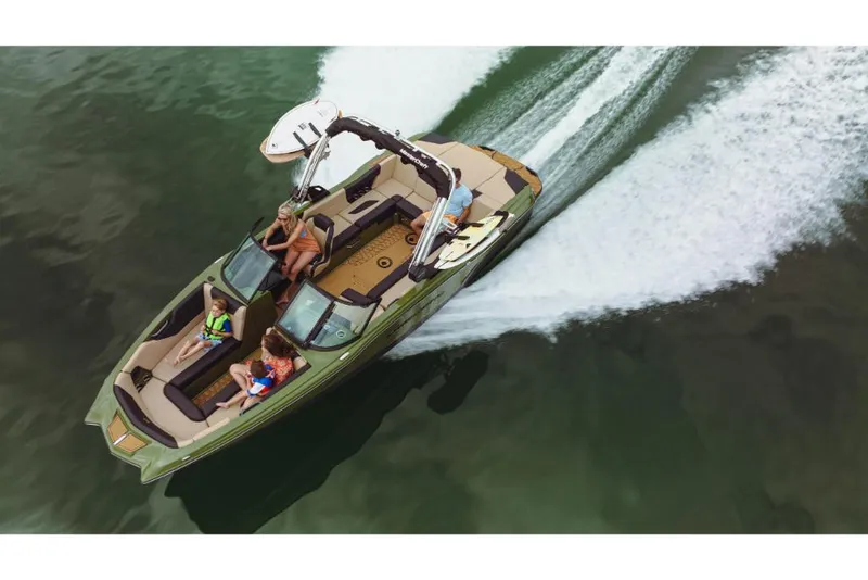Slide: The Image of 2023 MasterCraft NXT24 boat cruising on water with passengers. - 2