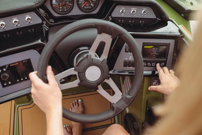 Slide: The Image of 2023 MasterCraft NXT24 boat dashboard with steering wheel and control panel. - 4