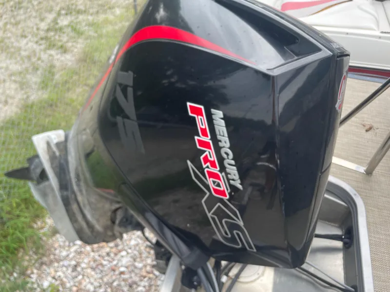 Slide: The Image of Mercury Pro XS outboard motor on a 2021 Manitou 230 Aurora LE boat. - 15