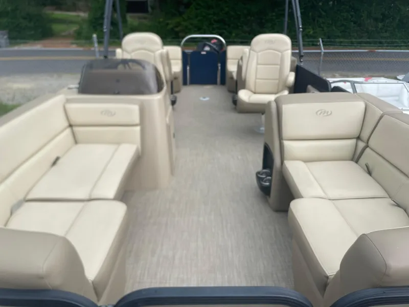 Slide: The Image of 2021 Manitou 230 Aurora LE pontoon boat with beige seating and spacious deck. - 5