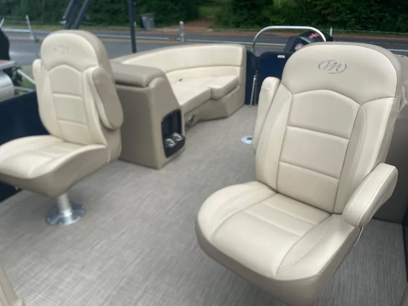 Slide: The Image of 2021 Manitou 230 Aurora LE boat interior with beige leather seats. - 8