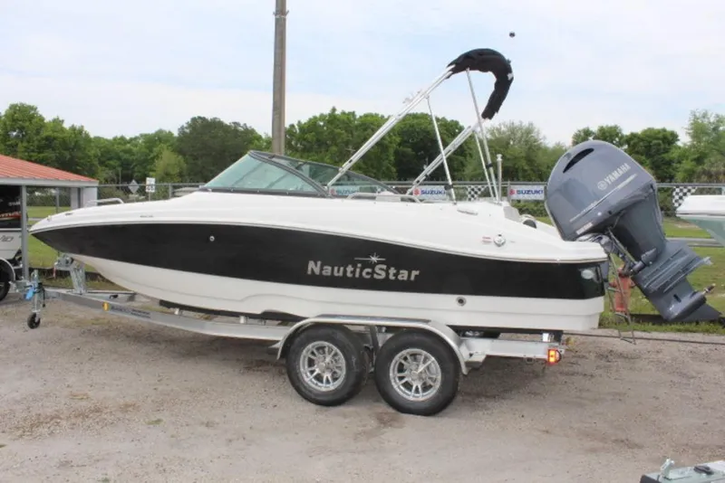 Slide: The Image of 2023 NauticStar 203 DC boat on a trailer with Yamaha outboard motor. - 12