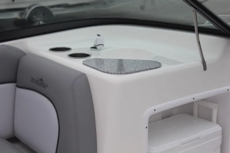 Slide: The Image of 2023 NauticStar 203 DC boat interior with sink and storage compartment. - 2