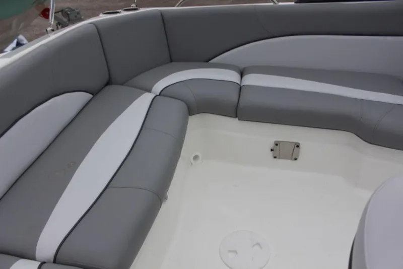 Slide: The Image of 2023 NauticStar 203 DC boat interior with gray and white cushioned seating. - 3
