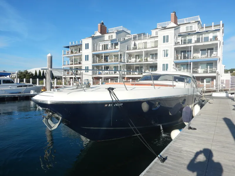 Slide: The Image of 2004 Baia 54 yacht docked near luxury waterfront apartments. - 10