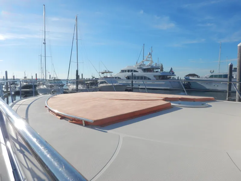Slide: The Image of 2004 Baia 54 yacht deck with marina view under clear blue sky. - 17