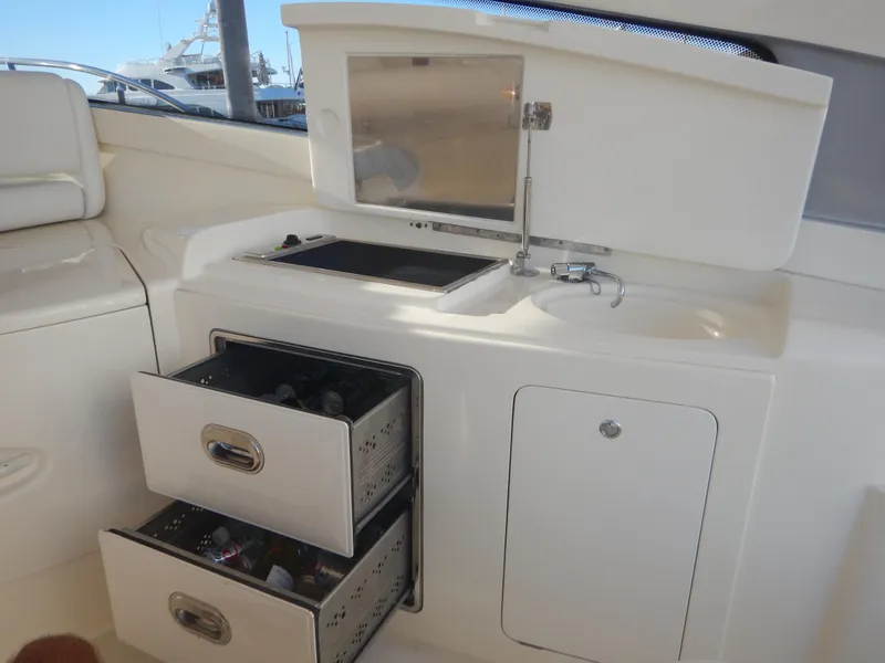 Slide: The Image of 2004 Baia 54 yacht interior with sink, storage drawers, and countertop. - 19