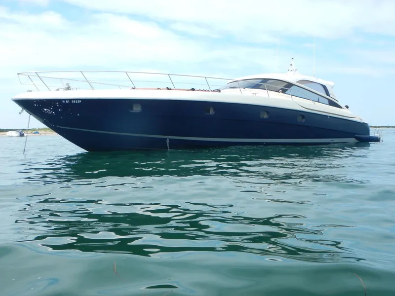 Slide: The Image of 2004 Baia 54 yacht on calm water under a clear sky. - 2