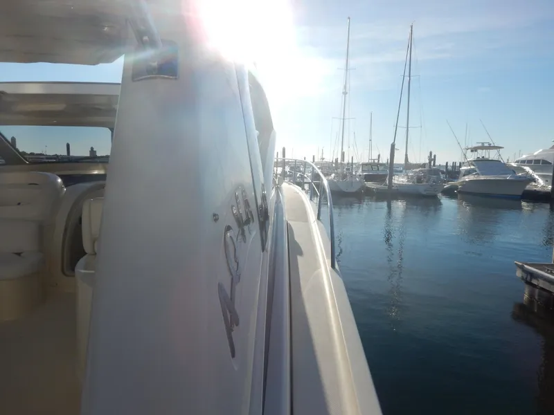 Slide: The Image of 2004 Baia 54 yacht docked in a sunny marina with sailboats. - 20