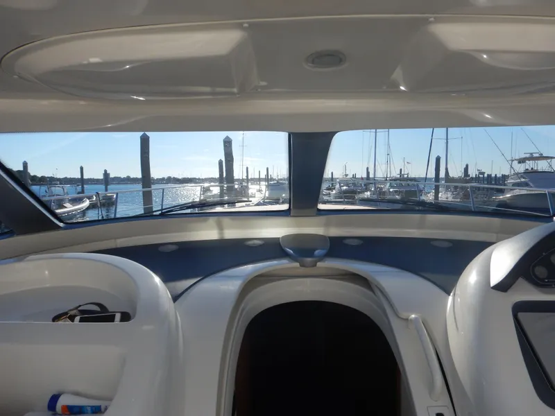 Slide: The Image of Interior view of 2004 Baia 54 yacht cockpit overlooking marina with boats. - 21