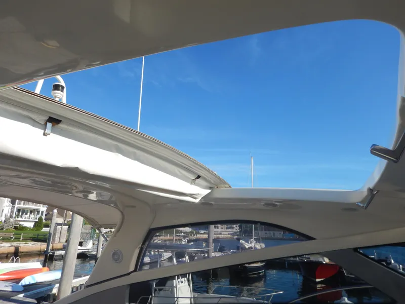 Slide: The Image of Open sunroof view on a 2004 Baia 54 yacht, docked at a marina. - 22
