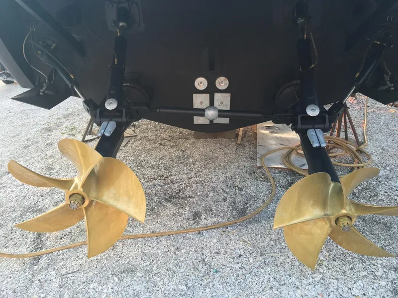 Slide: The Image of Twin propellers of a 2004 Baia 54 yacht on gravel surface. - 28