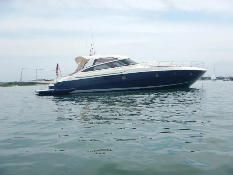 Slide: The Image of 2004 Baia 54 yacht on calm water, side view with clear sky. - 3