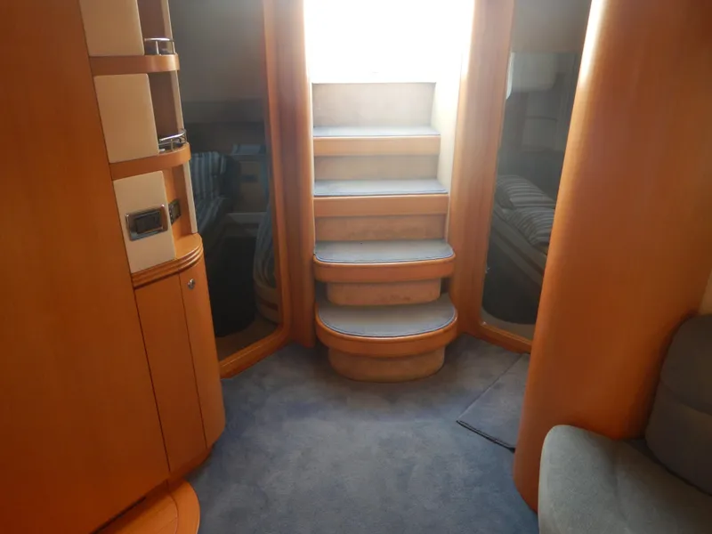 Slide: The Image of Interior of 2004 Baia 54 yacht with wooden stairs and modern design elements. - 30