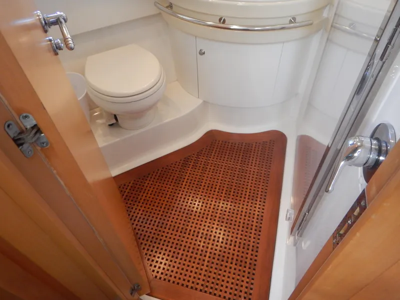 Slide: The Image of Bathroom interior of 2004 Baia 54 yacht with wooden floor mat and modern fixtures. - 39