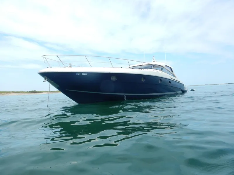 Slide: The Image of 2004 Baia 54 yacht on calm water under a clear sky. - 4