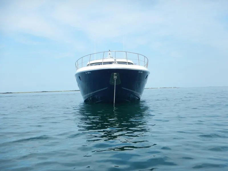 Slide: The Image of Front view of a 2004 Baia 54 yacht on calm water. - 5