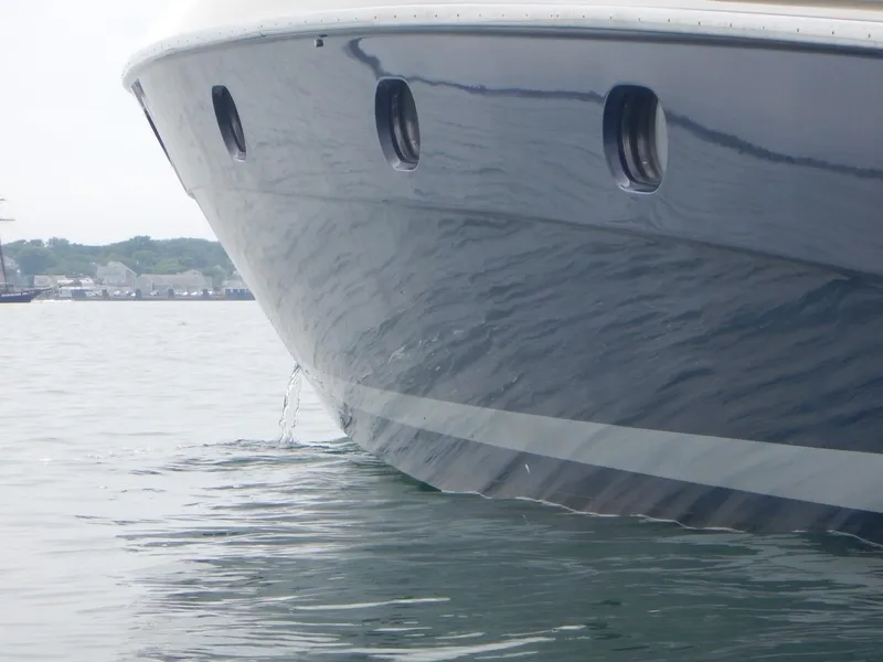 Slide: The Image of Bow of 2004 Baia 54 yacht on calm water, showcasing sleek design. - 6