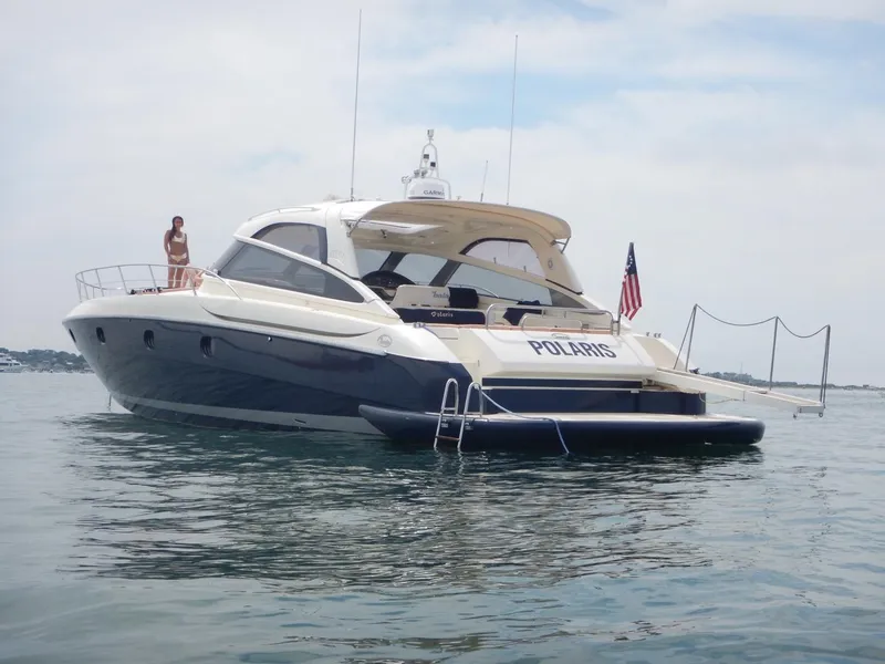 Slide: The Image of 2004 Baia 54 yacht on water with American flag and person on deck. - 7